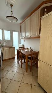a kitchen with a table and chairs and a refrigerator at Neoclassical apartment in kadmia in Thiva +23 photos