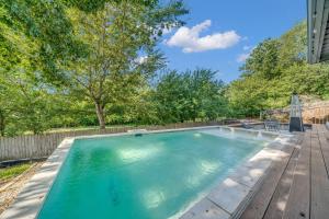 a swimming pool in a backyard with a wooden deck at Quiet Family Friendly Getaway - Pool, 2 King Beds in San Antonio