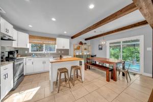 a kitchen with a wooden table and a dining room at Quiet Family Friendly Getaway - Pool, 2 King Beds in San Antonio