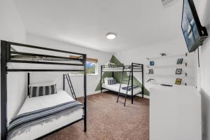a bedroom with two bunk beds and a desk at Quiet Family Friendly Getaway - Pool, 2 King Beds in San Antonio +23 photos