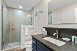 a bathroom with a sink and a shower and a toilet at Pine Acres 122 - Halfway to Heaven in Durango