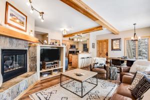 a living room with a fireplace and a tv at Take A Break In Breck in Breckenridge