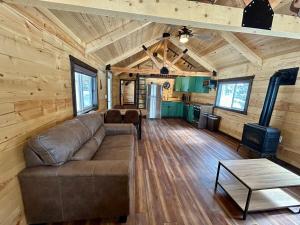 a living room with a couch and a stove at Index Peak Cabin in Silver Gate