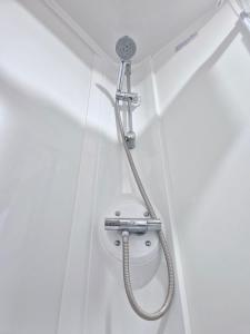a shower with a hose attached to a wall at Birchington Vale Trieste - Sleeps 8, pet friendly & Family friendly in Birchington +22 photos