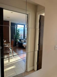 a mirror on a wall in a living room at Custom House Square Penthouse in Belfast