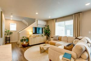 a living room with a couch and a tv at 13 Mi to Dtwn Denver Spacious Home with Balcony! in Denver