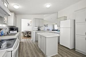 a kitchen with white appliances and a dining room at Pelican Point Paradise in Hackberry
