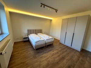 a bedroom with a bed and a closet in it at Apartment w domu pod orzechem in Gogolin +9 photos