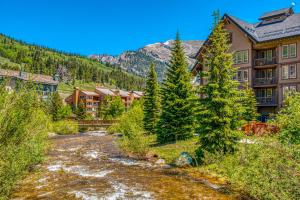 a river in front of a resort with a mountain at Lofty Quarters #409 in Wheeler Junction