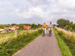 two people riding bikes down a trail at Wellness woning met sauna in Andijk