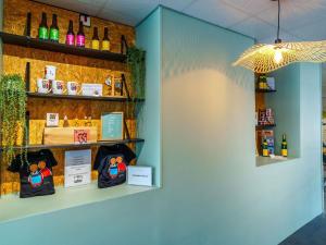 a room with bottles and bags on a shelf at Novotel Mulhouse Bâle Fribourg in Sausheim