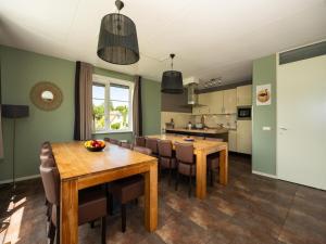 a kitchen and dining room with a table and chairs at Villa in Andijk with Hot Tub and Garden in Andijk