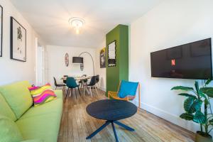 a living room with a couch and a table at Le Pop-up, Spacieux-Hyper centre-Lumineux in Limoges