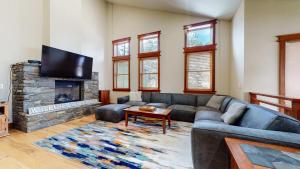 a living room with a couch and a fireplace at Red Slate Canyon - Modern 2-Story Condo in Mammoth Lakes