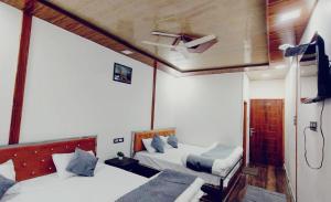 Katil atau katil-katil dalam bilik di Chitaav Voga Hotel
