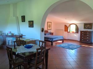 a living room with a table and a bed at Samur - Attic in Le Pastinelle