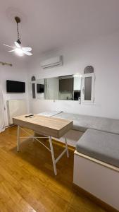 a living room with a table and a bed at Neoclassical apartment in kadmia in Thiva
