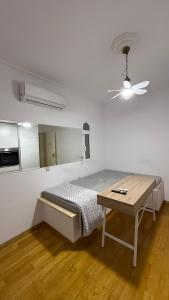 a white room with a bed and a table at Neoclassical apartment in kadmia in Thiva