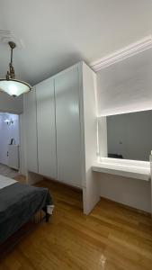 a room with a bed and a white cabinet at Neoclassical apartment in kadmia in Thiva +9 photos