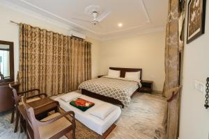 a small bedroom with a bed and a chair at Ziel Guest House Banigala Islamabad Near Gerrys & NIH Hospital in Islamabad