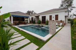 a swimming pool in the backyard of a house at Casa Grace Olón in Olón