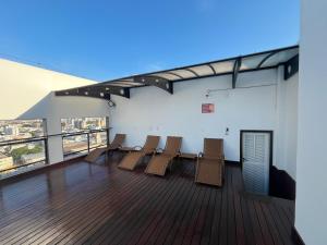 une pièce avec des chaises et une table sur un balcon dans l'établissement Conforto e Comodidade Jardim de Alah, à Campos dos Goytacazes