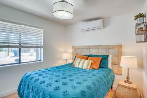 a bedroom with a blue bed and a window at Casita Anita - Charmer 1 Mi to Dtwn Tucson in Tucson
