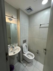a small bathroom with a toilet and a sink at Moroj Al Zain - M57 in Salalah