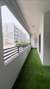 an empty corridor with green grass in a building at Moroj Al Zain - M57 in Salalah