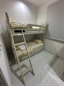 a bunk bed with a ladder in a room at Moroj Al Zain - M82 in Salalah