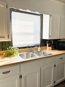 a kitchen counter with a sink and a window at Better than a Hotel - King / Bunkbed / Laundry in Gallatin