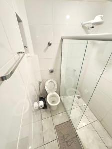 a bathroom with a toilet and a glass shower at VA Apart Hotel Savassi in Divinópolis +58 photos