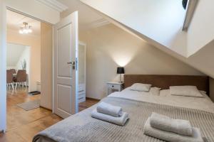 a bedroom with a bed with two towels on it at Apartament Filipek in Szczawnica +9 photos