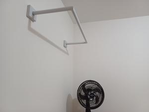 a fan in a room with a white wall at Apto central 3104 terreo com ar condicionado in Araçatuba