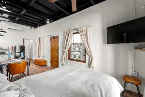 a bedroom with a bed and a desk and a window at The Artifact in San Diego