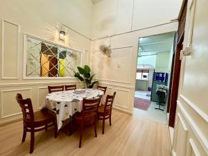 a dining room with a table and chairs and a stained glass window at D Erin Homestay in Banting