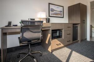 a office with a desk and a chair in a room at Coast Penticton Hotel in Penticton