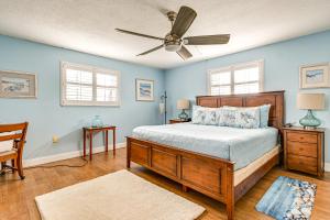 a bedroom with a bed and a ceiling fan at Steps to Sand Condo with Pool Access in Cocoa Beach in Cape Canaveral +18 photos