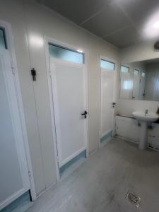a bathroom with white doors and a sink at DeepBlue sail boat in Lisbon +16 photos