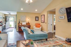 a living room with a couch and a piano at Hot Tub and Scenic Deck! Spacious Cookeville Retreat in Cookeville