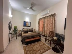 a bedroom with a bed and a television in it at ZaxisHome3 in Rawalpindi