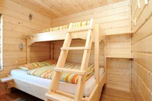 a bedroom with two bunk beds in a wooden cabin at Galå Fjällgård in Galåbodarna