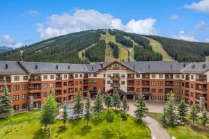 an apartment building with a mountain in the background at Small Town Feel Big Mountain Access in Frisco