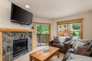 a living room with a fireplace and a flat screen tv at Small Town Feel Big Mountain Access in Frisco
