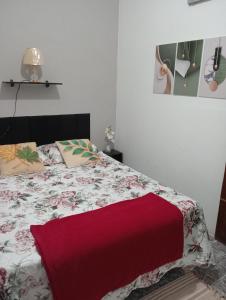 a bedroom with a bed with a red blanket at Fontinele's Home Apt 201 in Nova Iguaçu