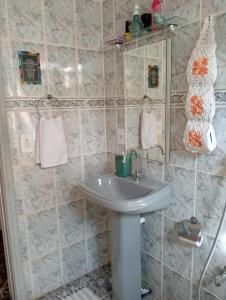 a bathroom with a sink and a mirror at Fontinele's Home Apt 201 in Nova Iguaçu