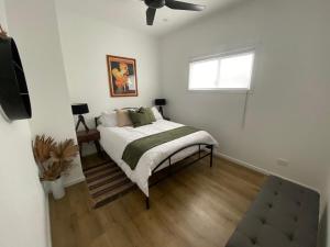 a bedroom with a bed and a window at Tranquility by the Lake in Karraganbah