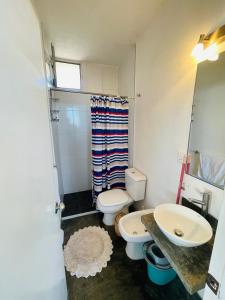 a bathroom with a toilet and a sink at Acacias PDD in Punta Del Diablo