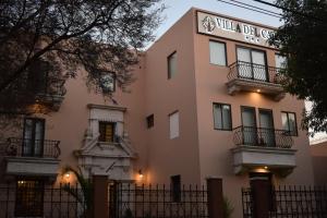 a pink building with a sign on it at Hotel Villa del Carmen in Arequipa