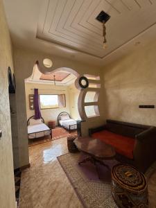 a living room with a couch and a table at Riad Mifis in Rissani +13 photos